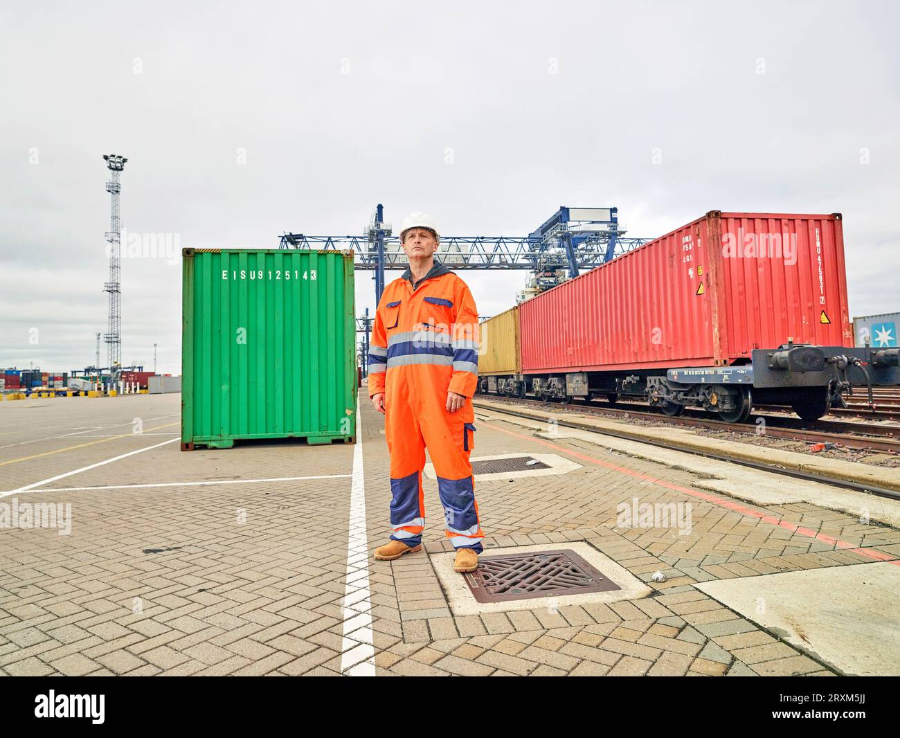 Dock worker by cargo train Stock Photo - Alamy