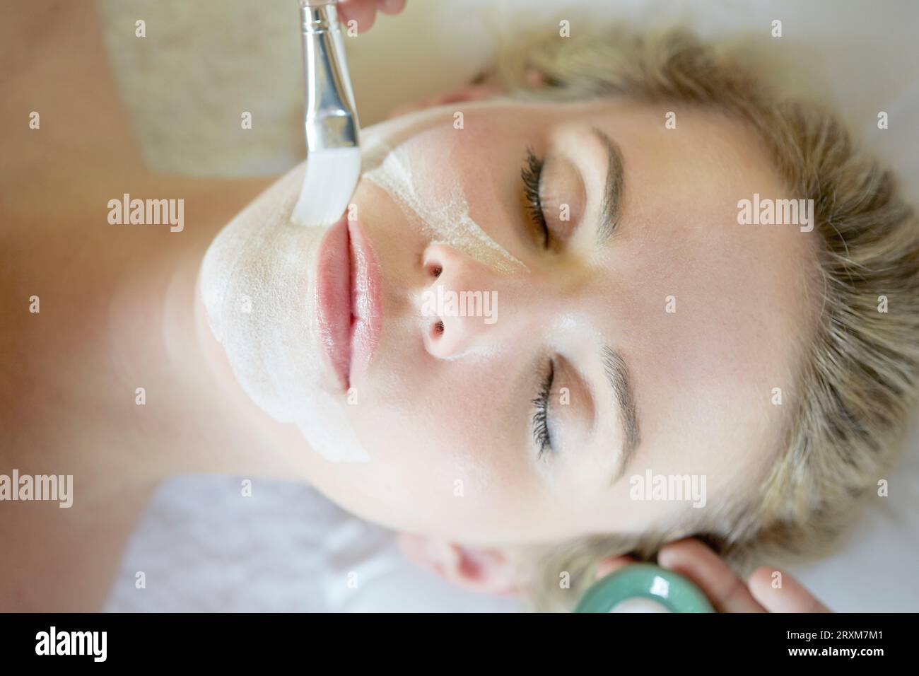 Blond woman mask face lying hi-res stock photography and images - Alamy