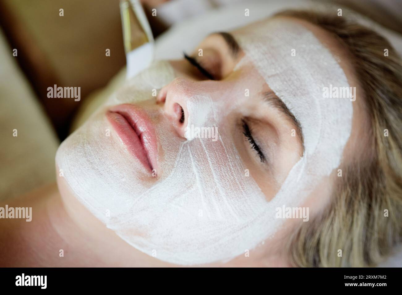 Blond woman mask face lying hi-res stock photography and images - Alamy