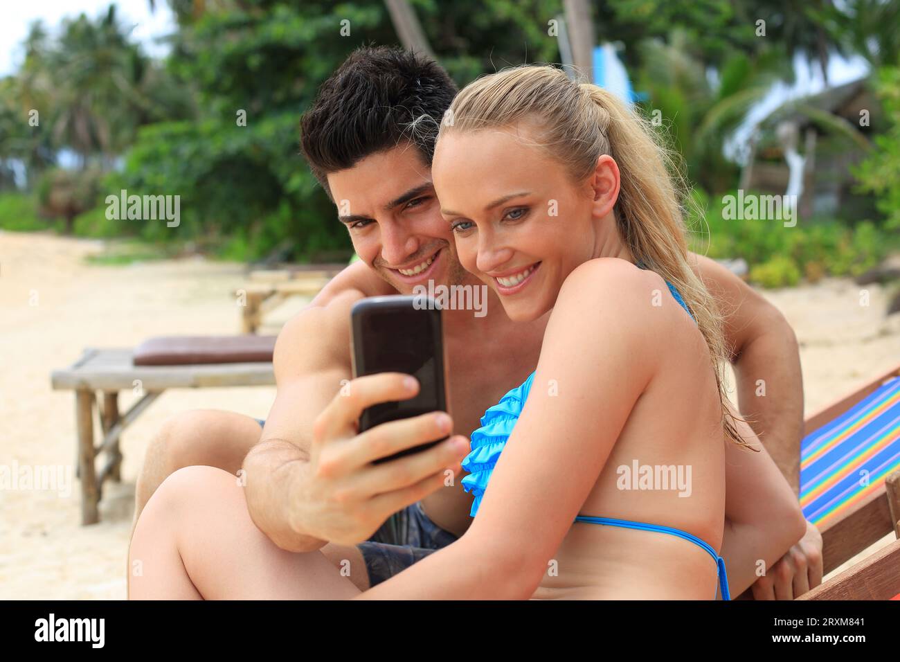 Young couple taking selfie on beach Stock Photo