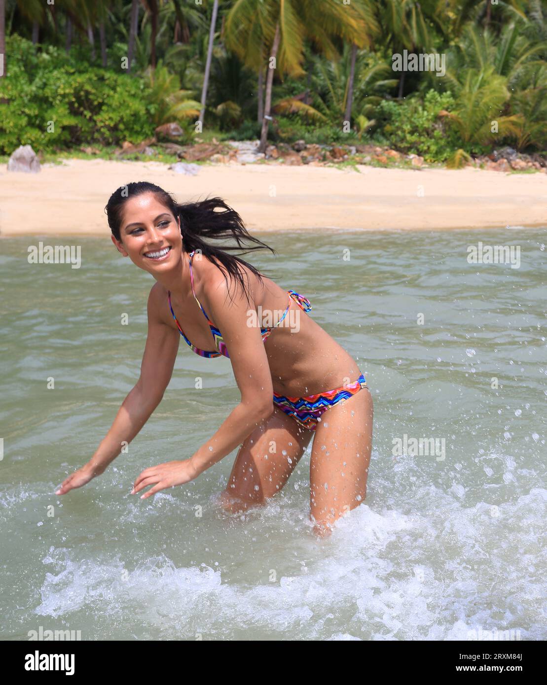 Mlata, Teenage girl wearing bikini, standing in the sea at Comino beach  stock photo
