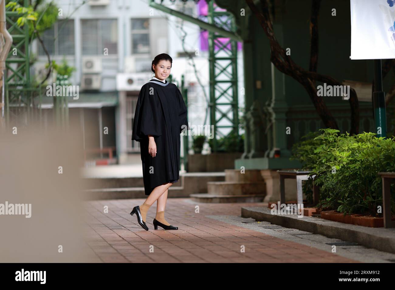 College graduate walking at university Bangkok Thailand Stock Photo