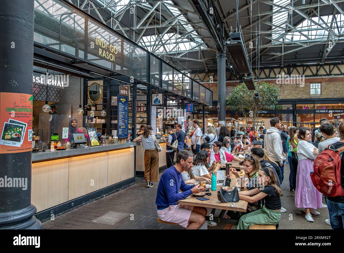People enjoying food from various food vendors at the food hall in Old