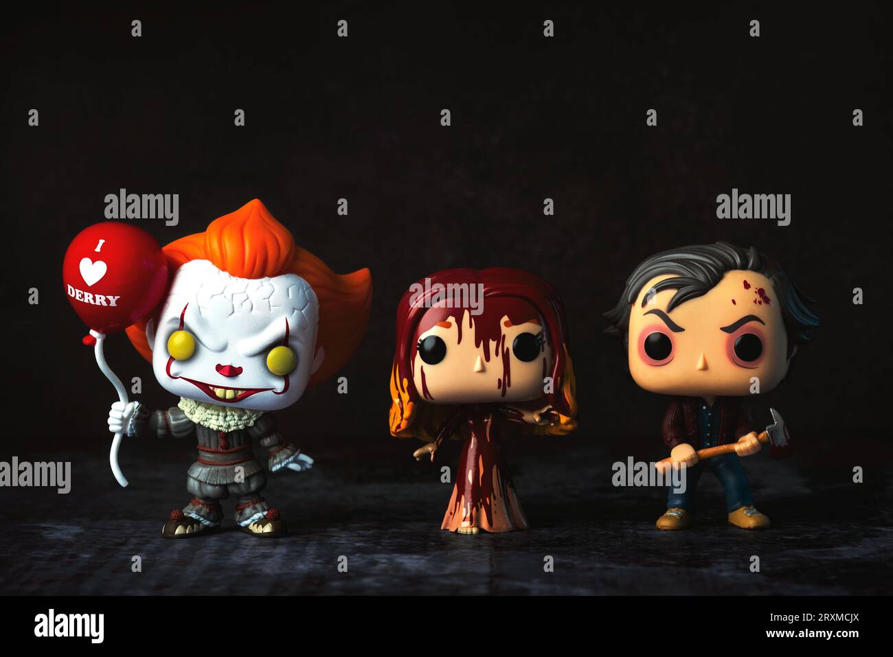 Funko POP vinyl figures of Pennywise, Carrie and Jack Torrance fictional characters from Stephen King books over grunge background. Illustrative edito Stock Photo