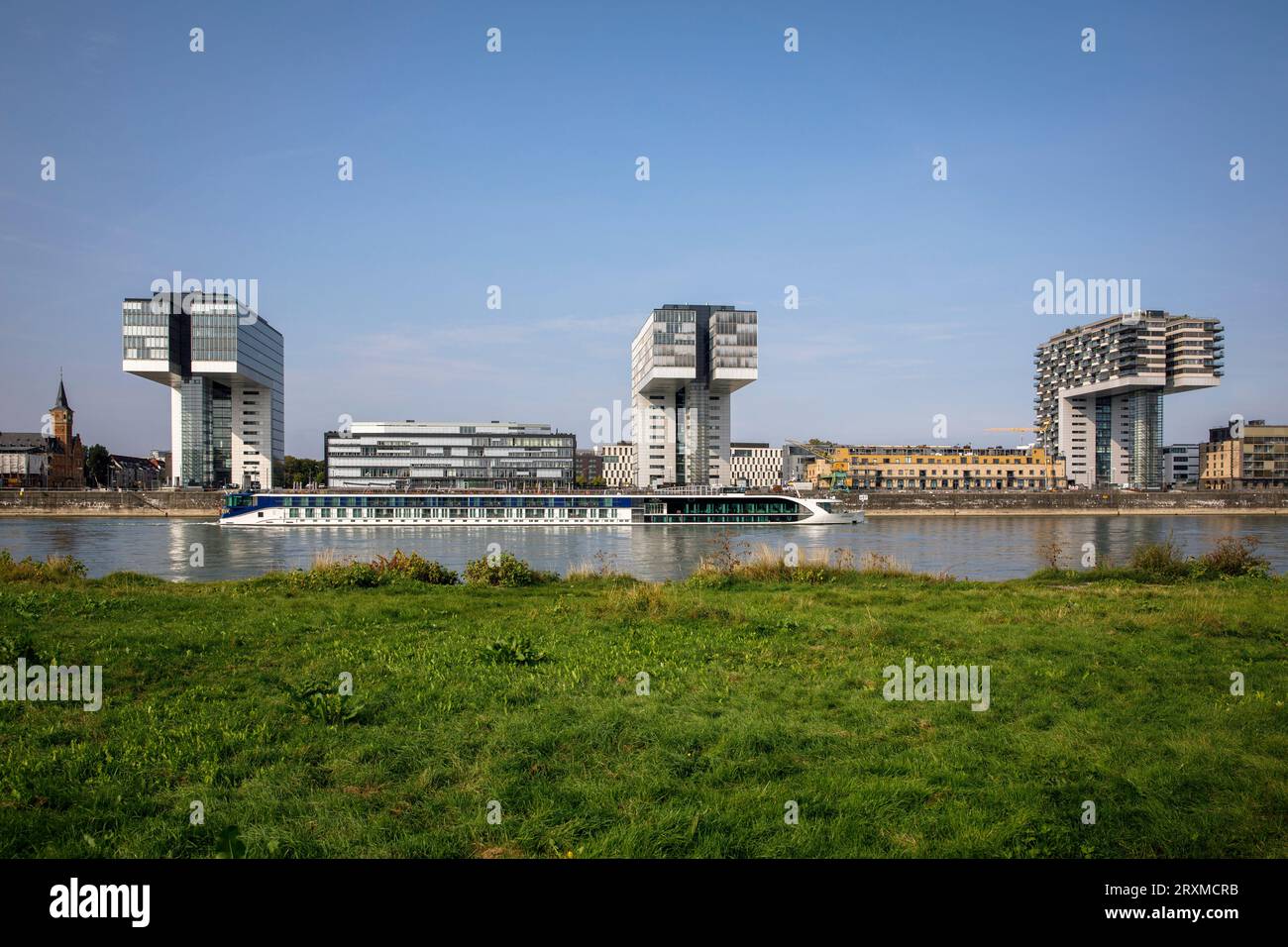 cruise ship in front of the Crane Houses in the Rheinau harbor, Cologne