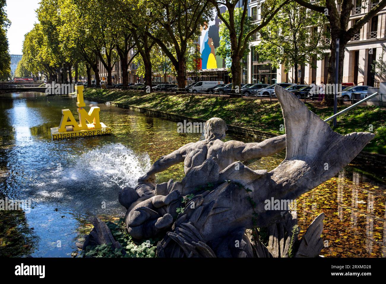 the Triton Fountain by Friedrich Coubillier at Koe-Graben on Koenigsallee, floating logo for the Invictus Games 2023, Duesseldorf, North Rhine-Westpha Stock Photo