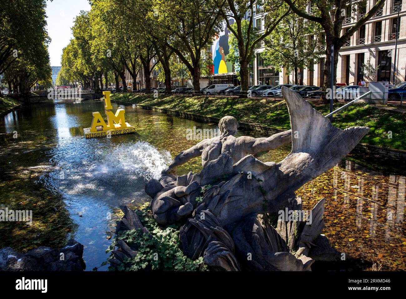 the Triton Fountain by Friedrich Coubillier at Koe-Graben on Koenigsallee, floating logo for the Invictus Games 2023, Duesseldorf, North Rhine-Westpha Stock Photo