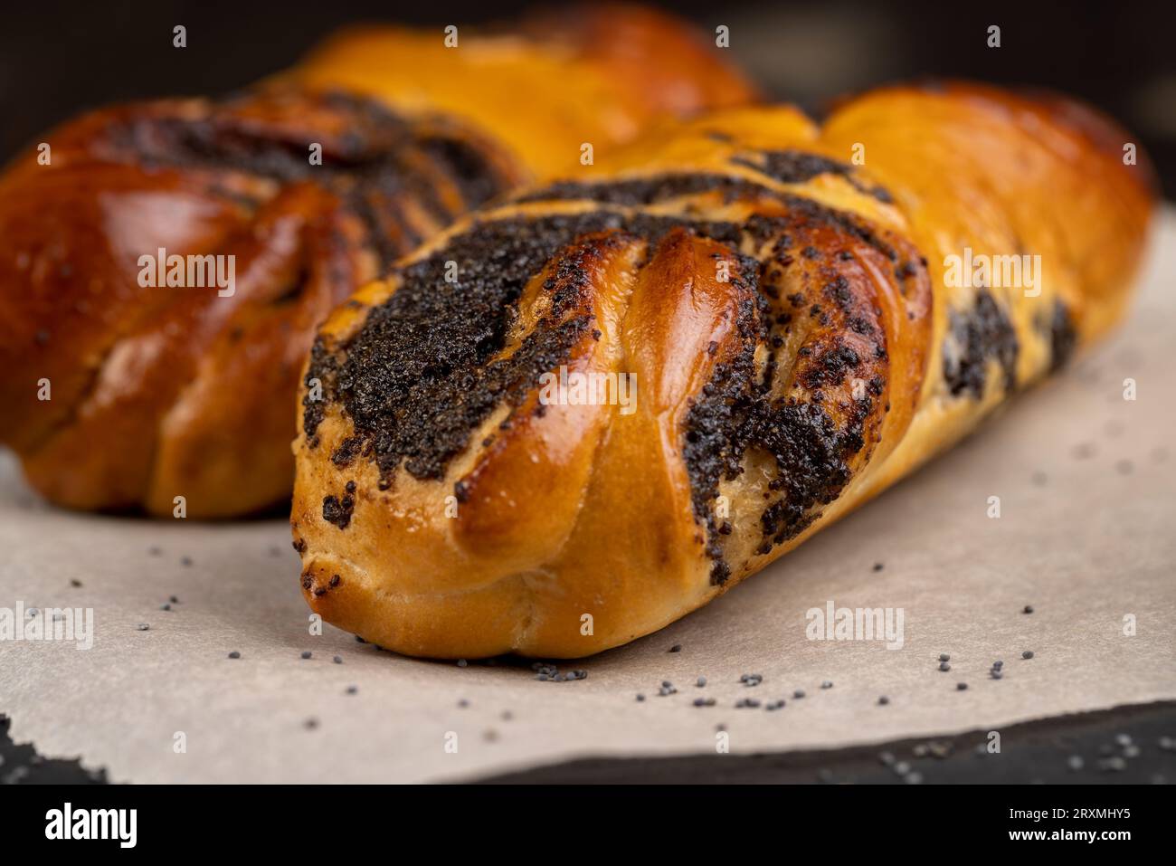Wheat bun with poppy seed filling, a large amount of sweet poppy seed