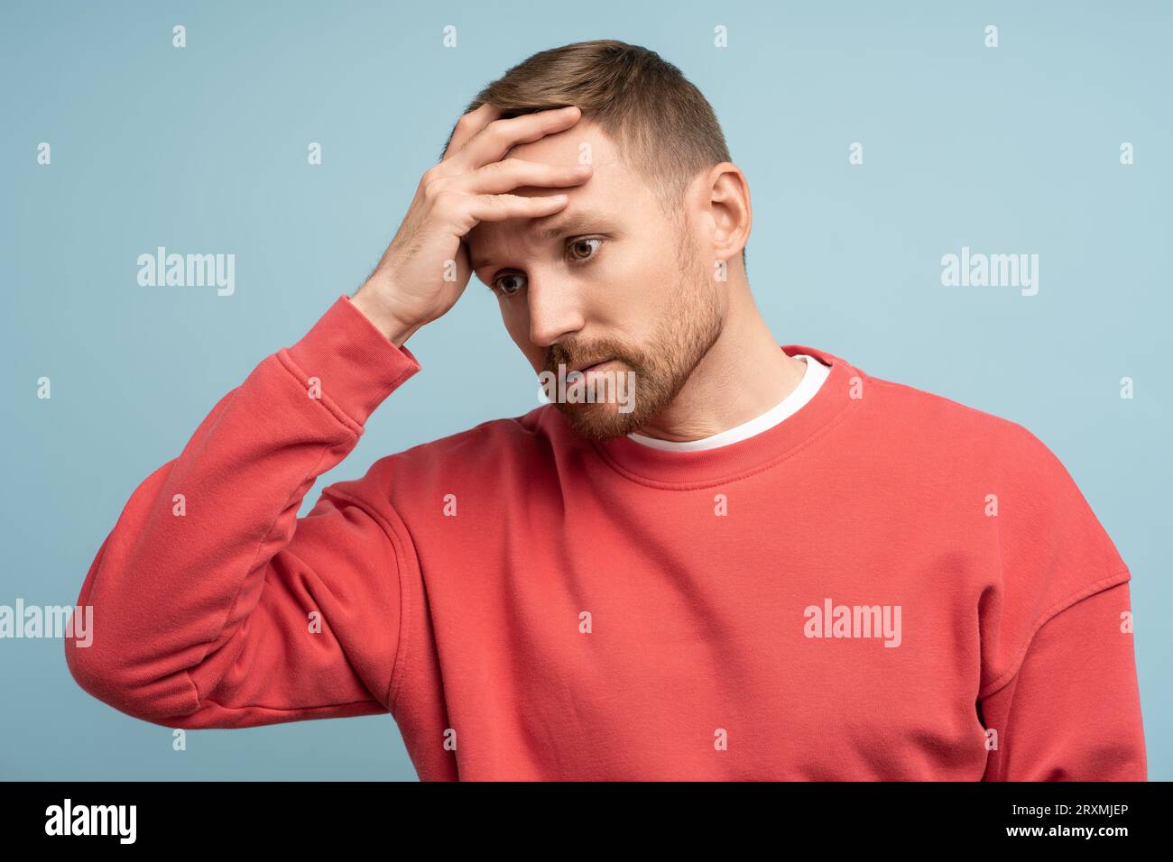 Man holds head with disappointed look. Emotional collapse mental breakdown hopelessness frustration Stock Photo