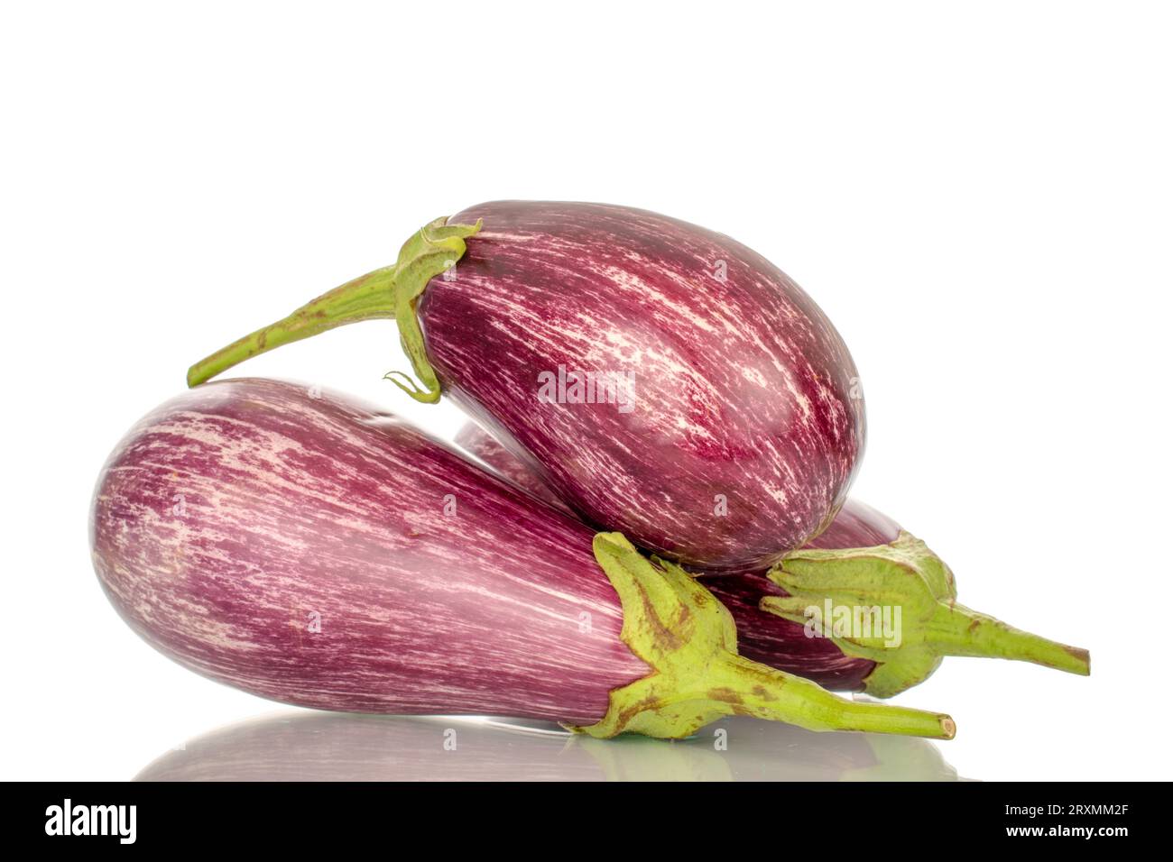 Three organic ripe eggplants, macro, isolated on white background. Stock Photo