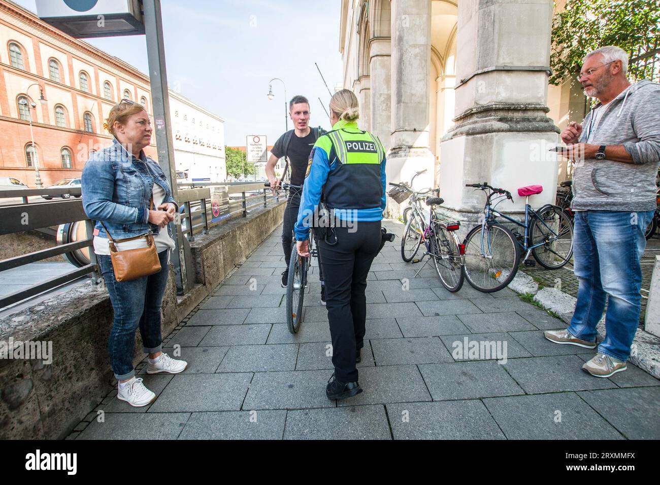 September 26, 2023, Munich, Bavaria, Germany: A Munich police officer catches a person ridingv the wrong way on a sidewalk right into a ticket checkpoint. These riders are called ''Geisterfahrer''. Under the motto of ''sicher.mobil.leben â€“ RÃ¼cksicht im Blick'' the Bavarian Police joined their counterparts nationwide to carry out a national action for traffic safety with a focus on speeding, cars driving on sidewalks, vehicles parking on cycling paths, dangerous and close overtaking of cyclists. In the case of the latter, cyclists have complained in Munich that the paths are mostly being use Stock Photo