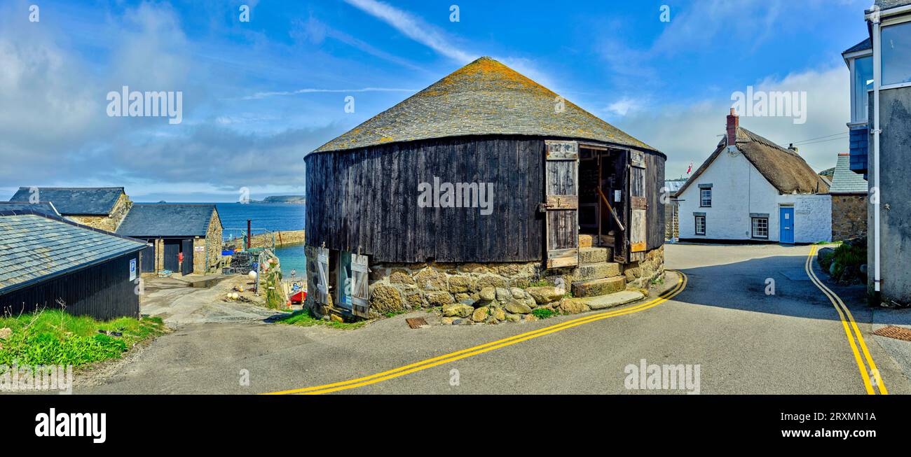 Asphalt road stretching between coastal houses, Sennen Cove, England, UK Stock Photo