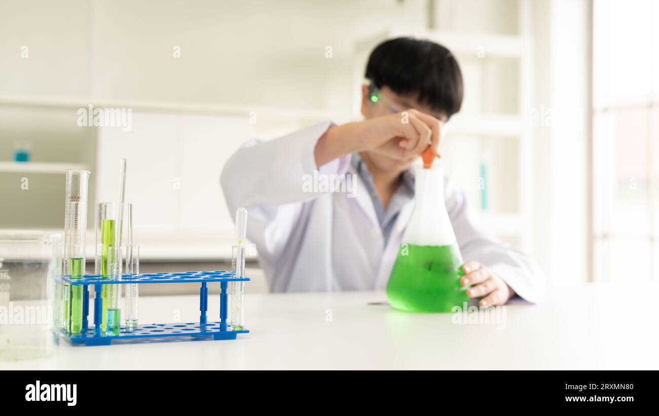 Children scientist learning on biology and chemistry in the laboratory. A STEM education learning concept. An Asian student boy studying with chemistr Stock Photo