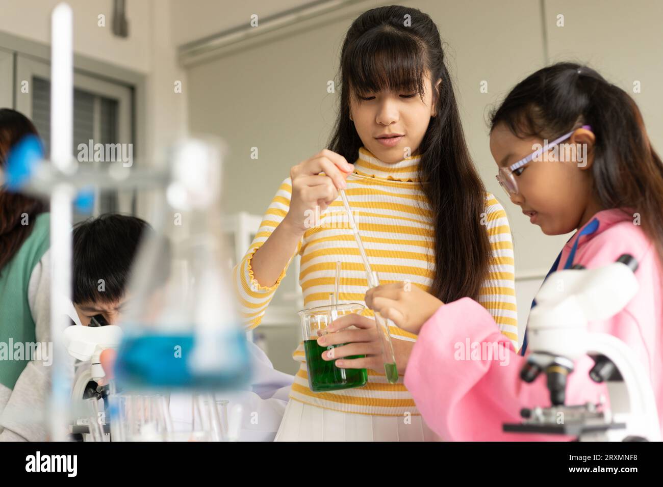 Children scientist doing science experiment test with chemistry in a