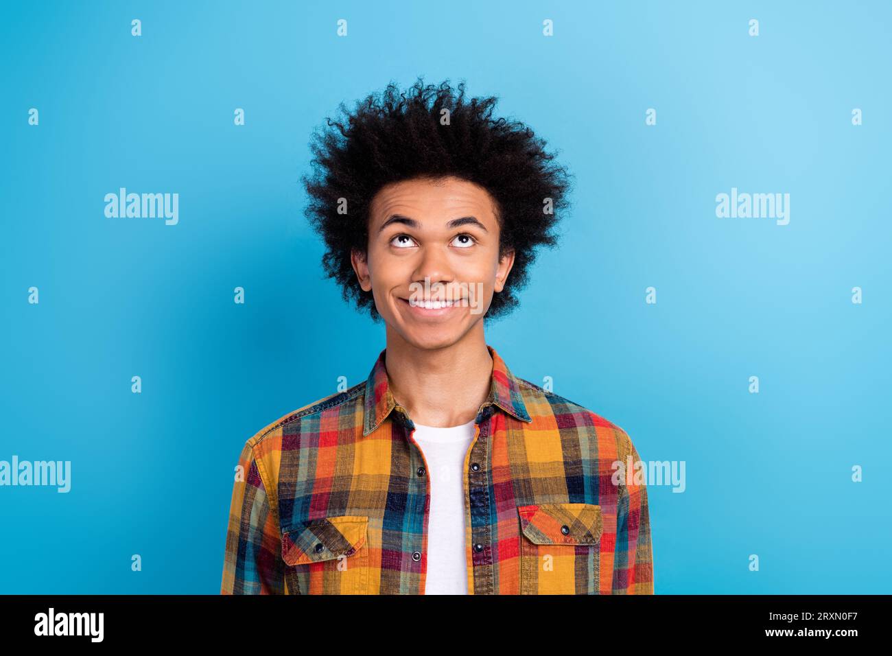 Portrait of toothy beaming guy with perming coiffure dressed checkered ...