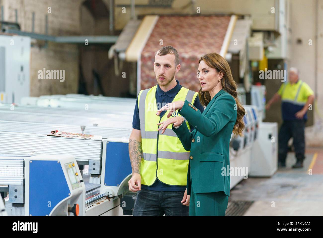The Princess of Wales looks at printing machinery in operation with printer Matt Craven during a visit to Standfast & Barracks printworks in Lancaster. The company is renowned for its impressive heritage in textile design and creativity, which dates back to 1924 and is now part of the Sanderson Design Group. Picture date: Tuesday September 26, 2023. Stock Photo