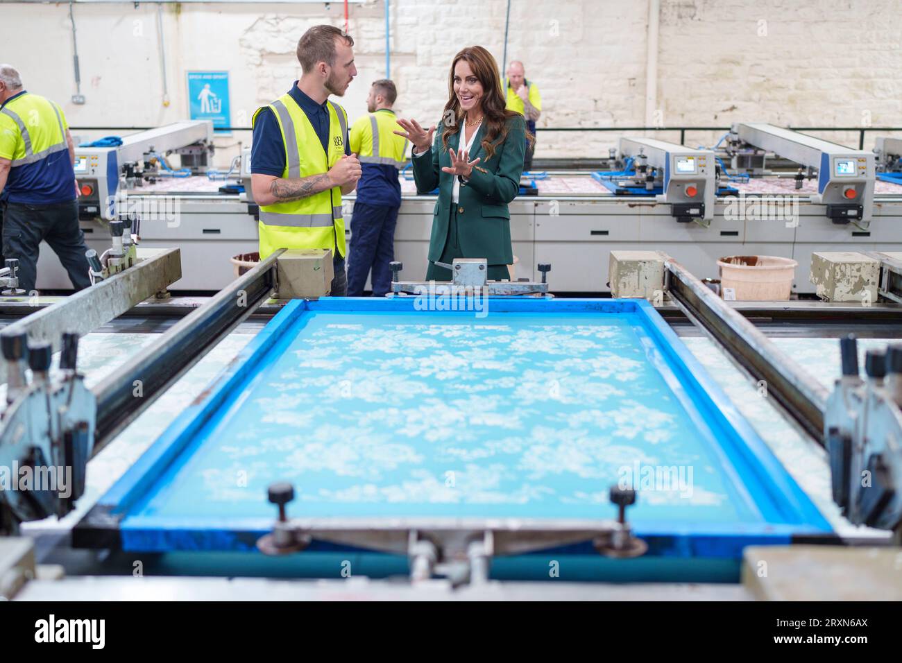 The Princess of Wales looks at printing machinery in operation with printer Matt Craven during a visit to Standfast & Barracks printworks in Lancaster. The company is renowned for its impressive heritage in textile design and creativity, which dates back to 1924 and is now part of the Sanderson Design Group. Picture date: Tuesday September 26, 2023. Stock Photo