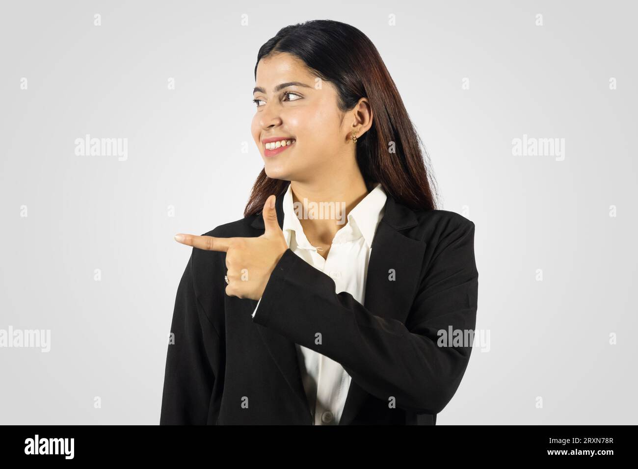 Beautiful and Happy Smiling Asian Young Girl from Nepal giving several gestures in a formal dress Stock Photo