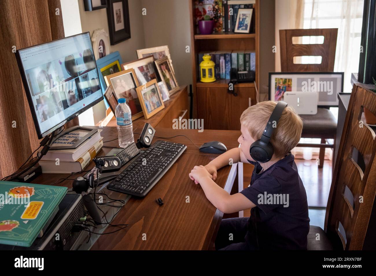 Young boy, first class primary school, studying with a distance ...