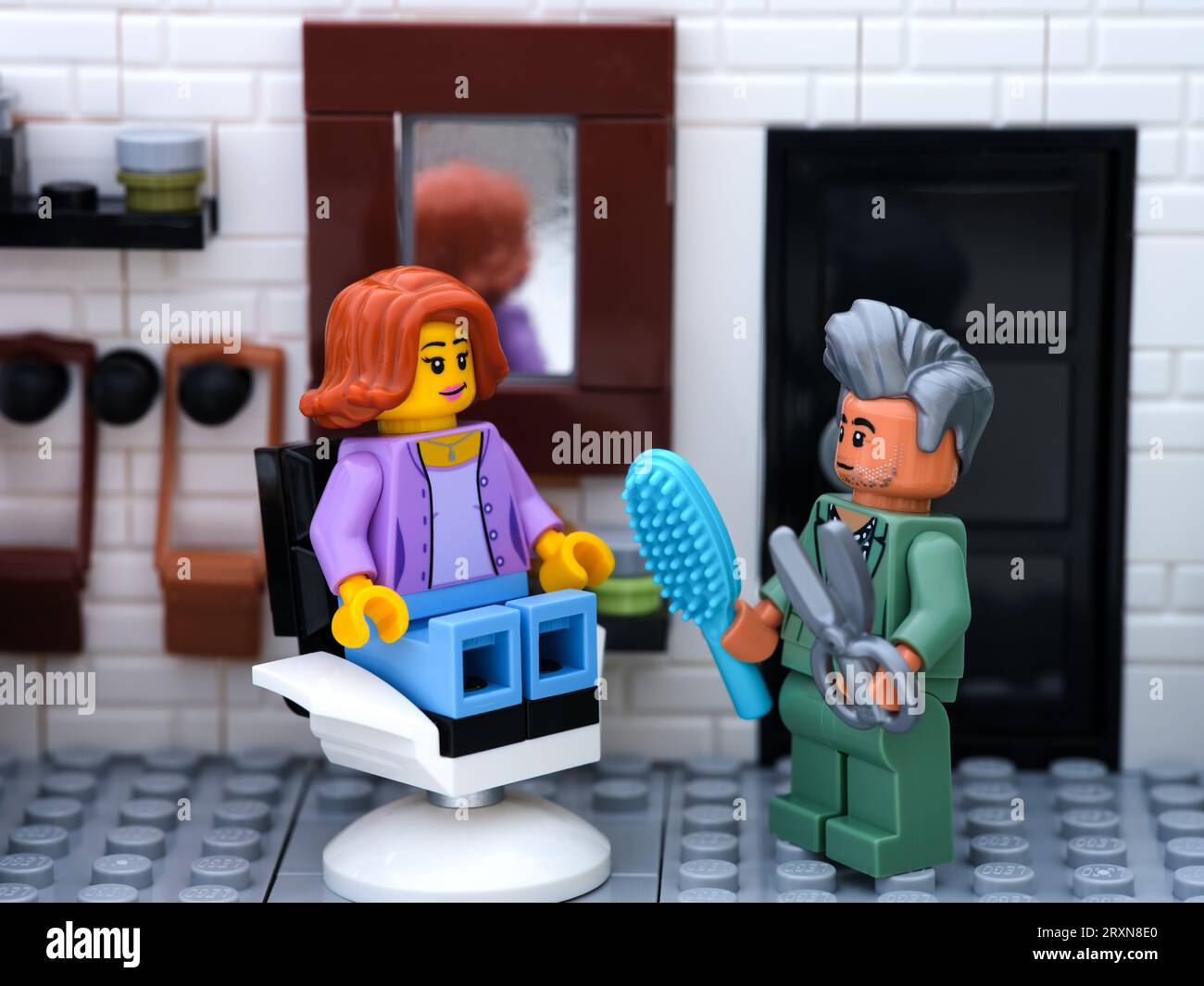 Tambov, Russian Federation - September 24, 2023 A Lego woman minifigure getting a haircut in a barber shop Stock Photo