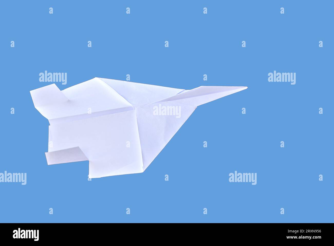 White paper plane isolated on blue background Stock Photo