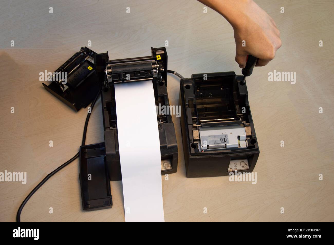 Top view. Technician repairing printer, thermal printer. Stock Photo