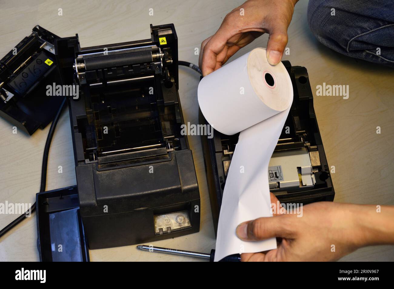 Top view. Technician repairing printer, thermal printer. Stock Photo