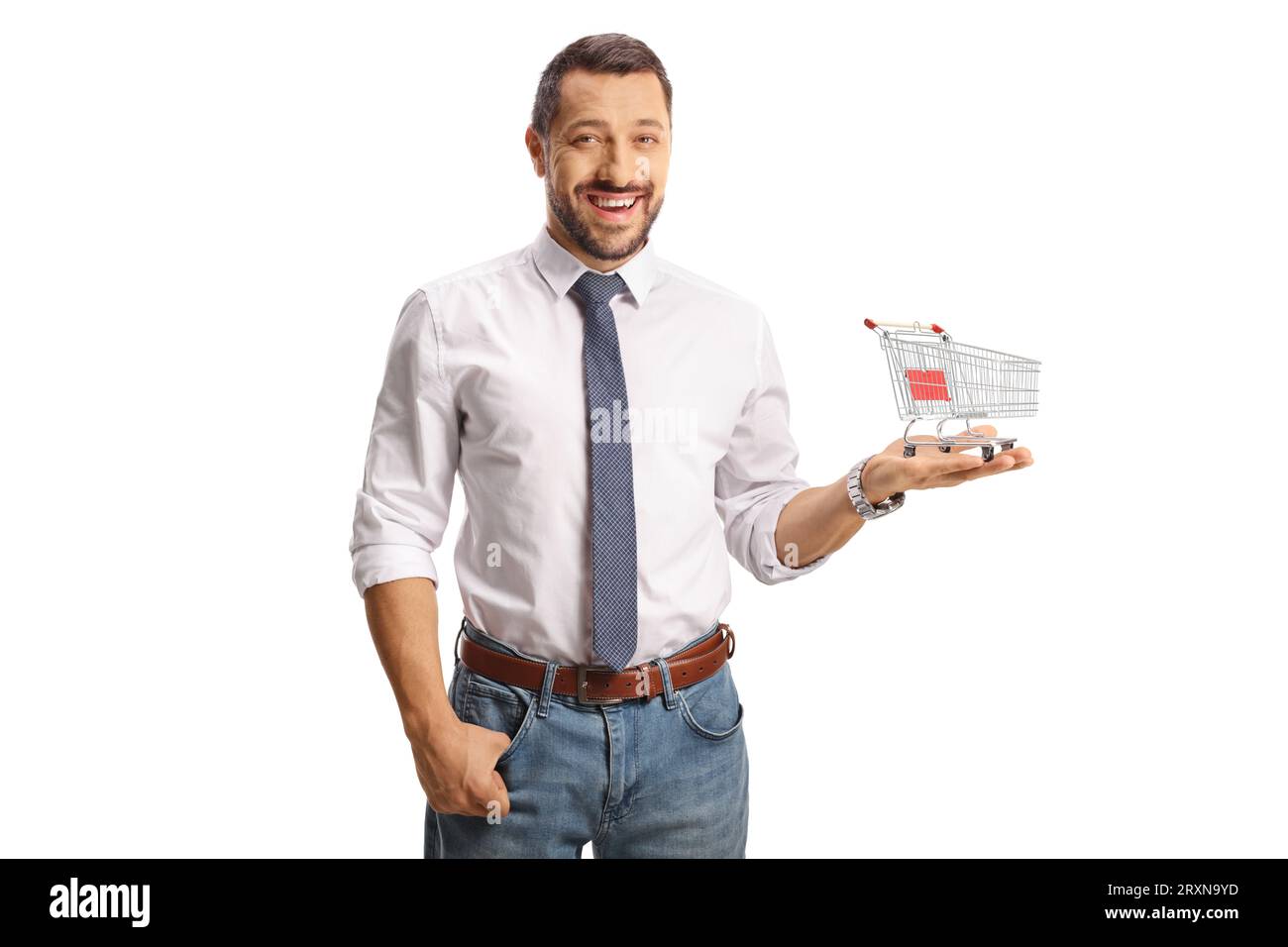 Young smiling man holding a small shopping cart on his palm isolated on white background Stock Photo