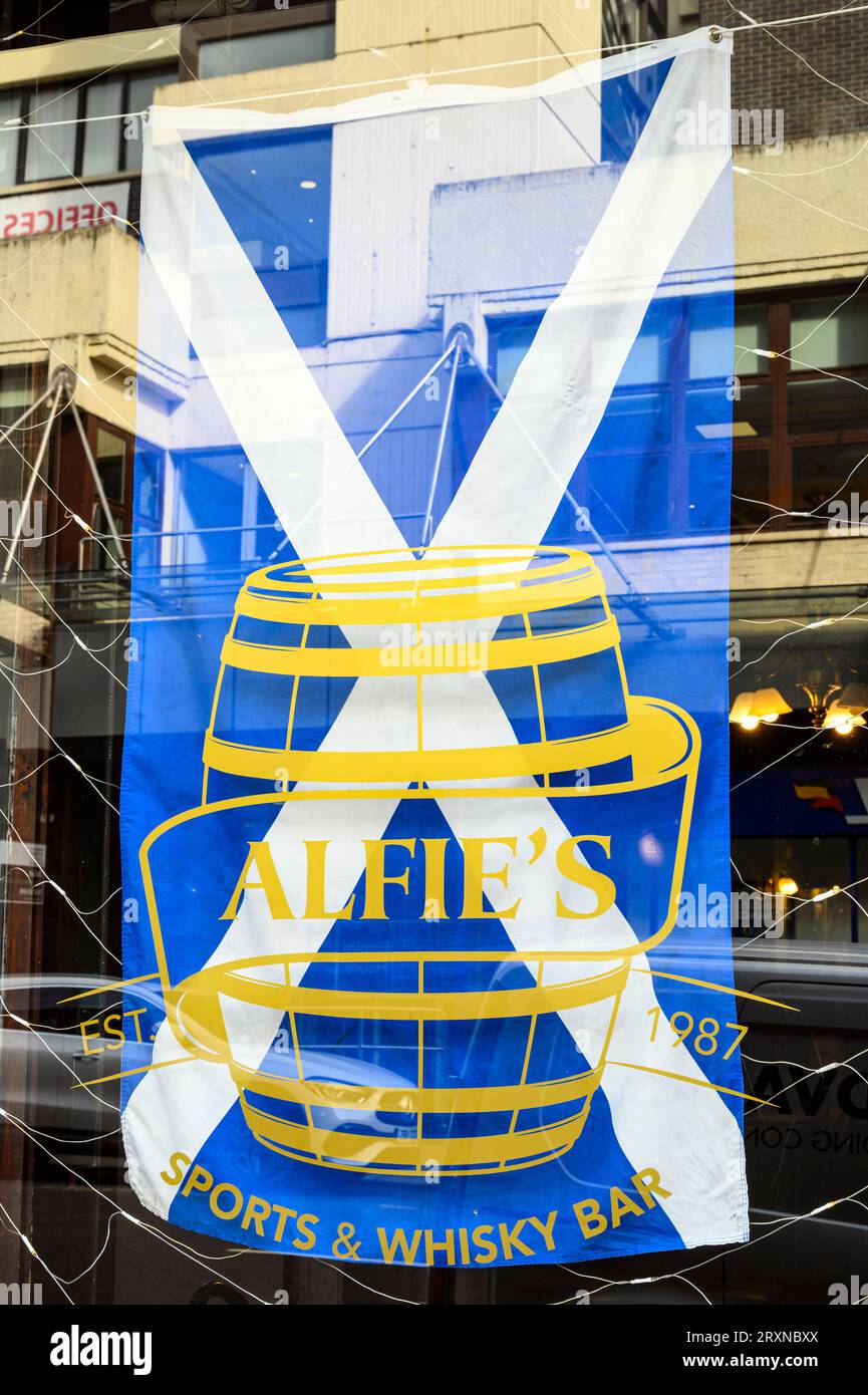 Scottish Flag displayed in the window of Alfie's Sports and Whisky bar, West Nile Street, Glasgow, Scotland, UK, Europe Stock Photo