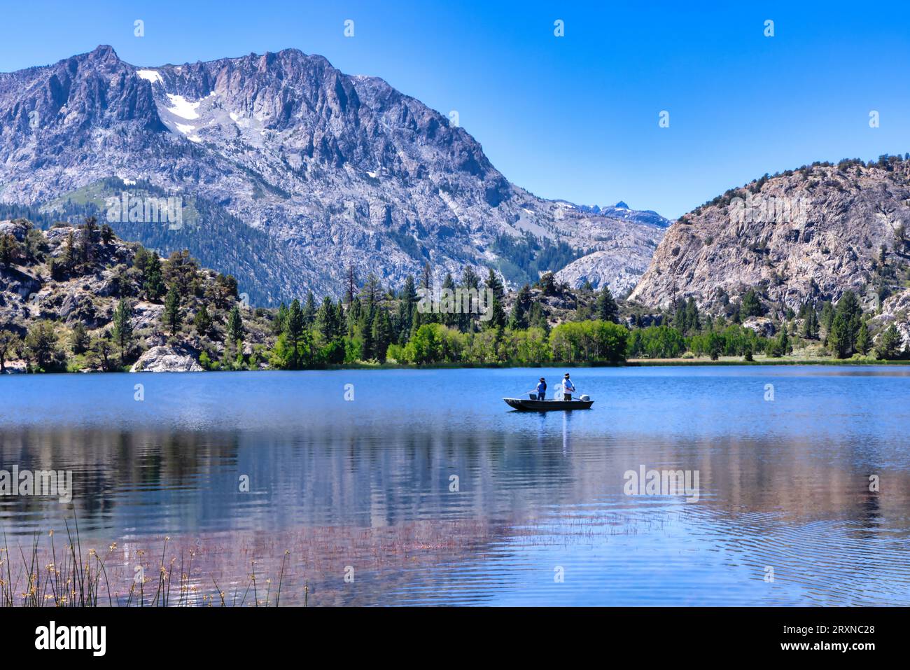 Two fishermen on a boat at June lake in Mono County, California Stock Photo
