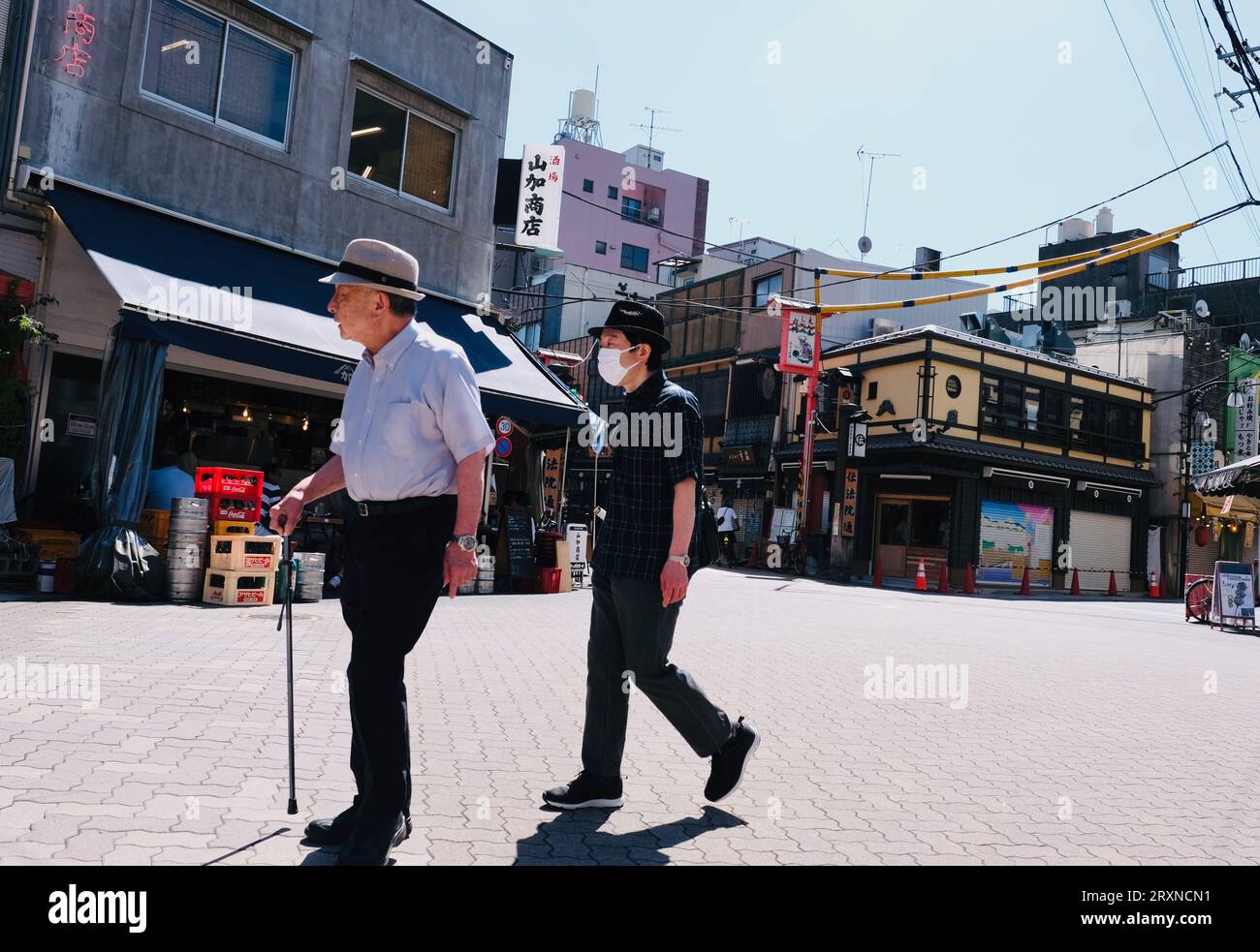 Two elderly Japanese men walk along the road in Asakusa,Tokyo, Japan Stock Photo