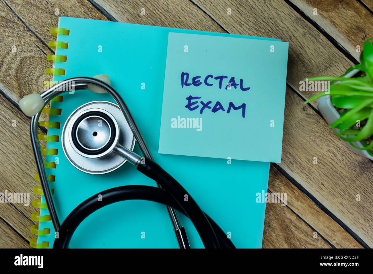 Concept of Rectal Exam write on sticky notes with stethoscope isolated on Wooden Table. Stock Photo