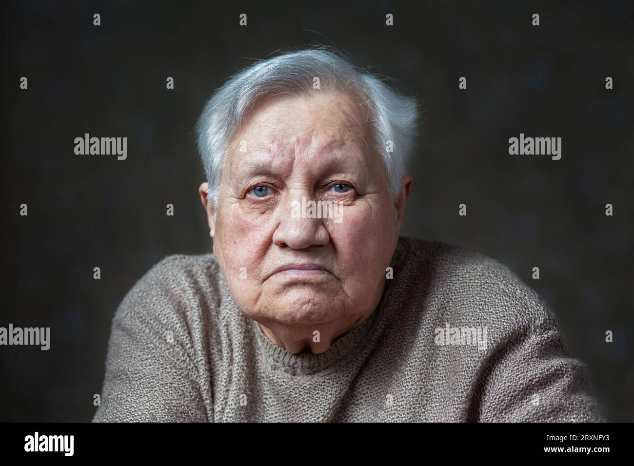 Portrait of an elderly, sad woman in the studio Stock Photo