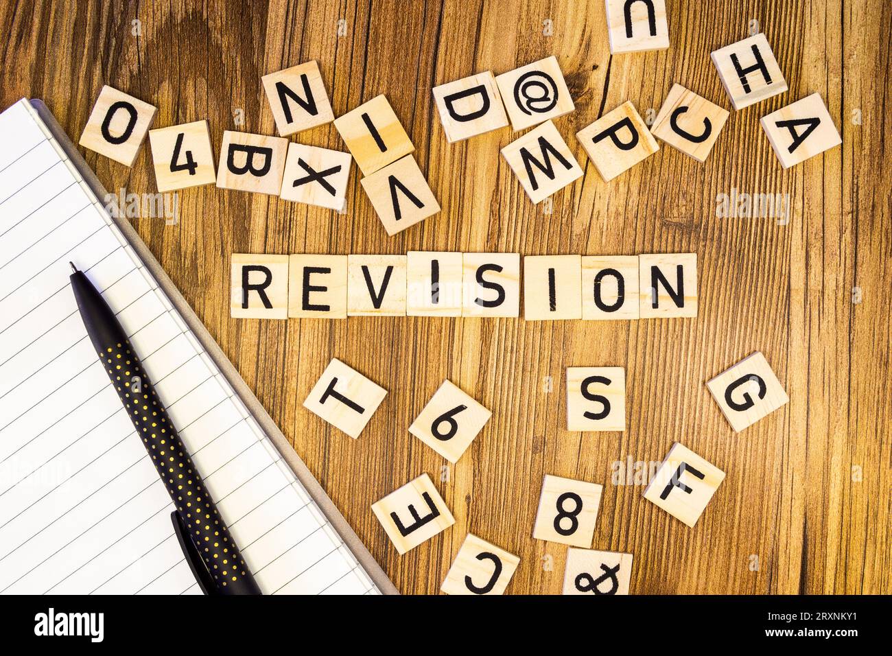Revision flat lay scattered letters with notebook and pen Stock Photo