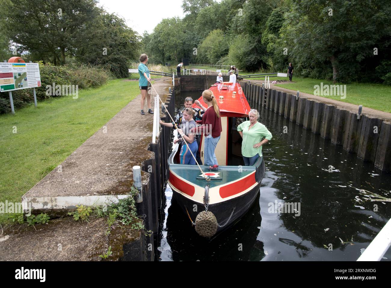 Family enjoying day out on narrow boat negotiating Marcliff lock on River Avon near Evesham UK Stock Photo