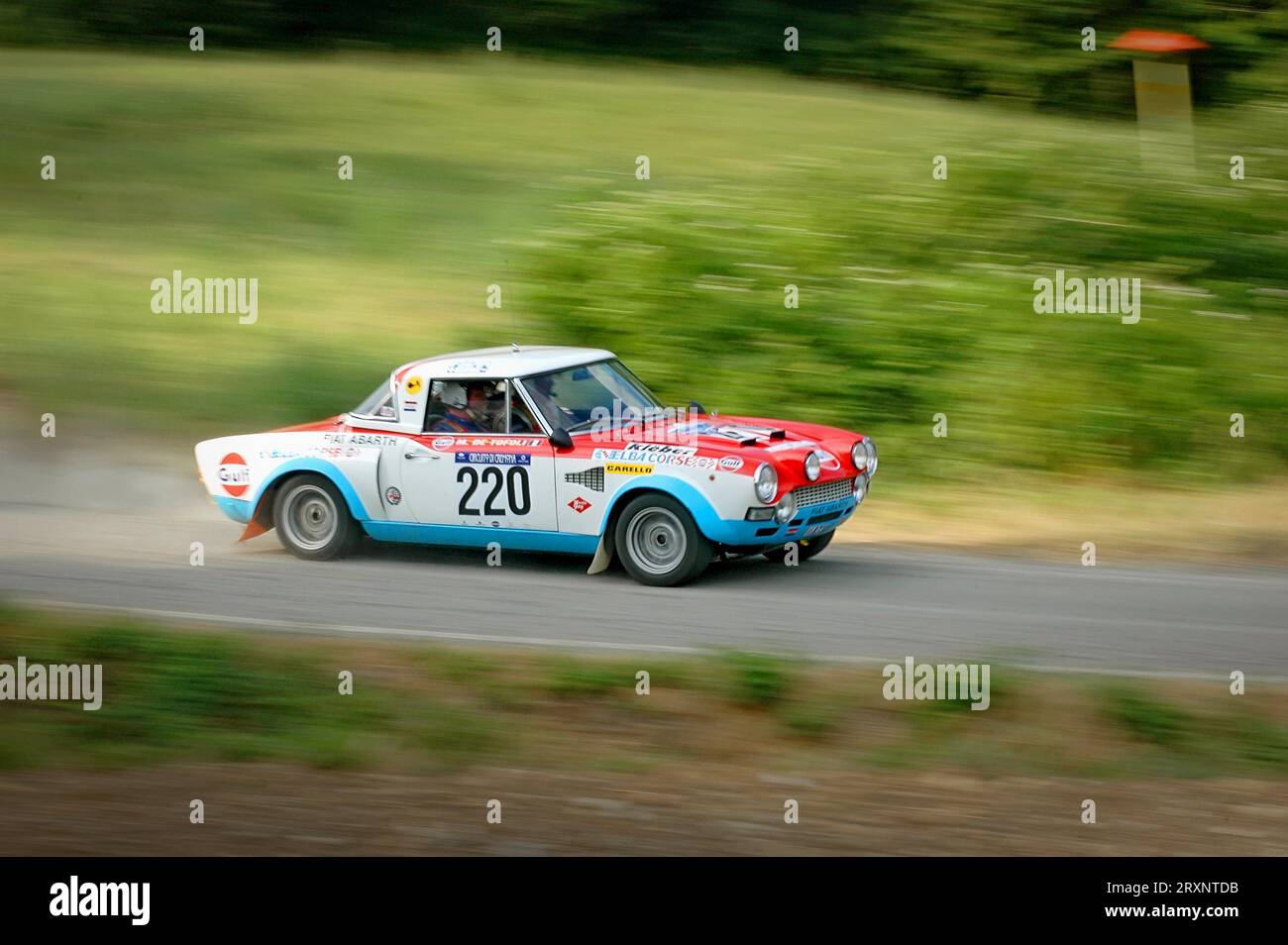 Italy - September 7, 2005 - Unidentified drivers on a white, blue and red vintage Fiat Abarth racing car Stock Photo