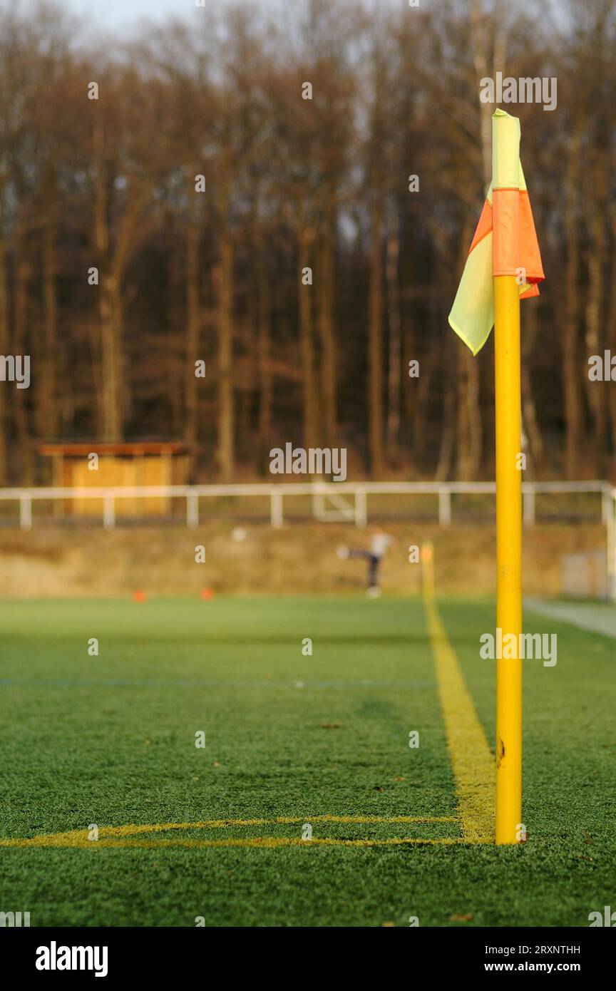 Corner post of a football pitch made of artificial turf with football