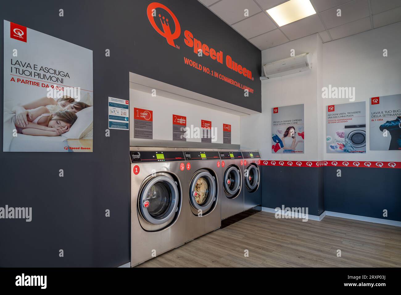 Fossano, Italy - September 26, 2023: Washing machines in Speed Queen chain self-service laundry, number one commercial laundry in the world Stock Photo