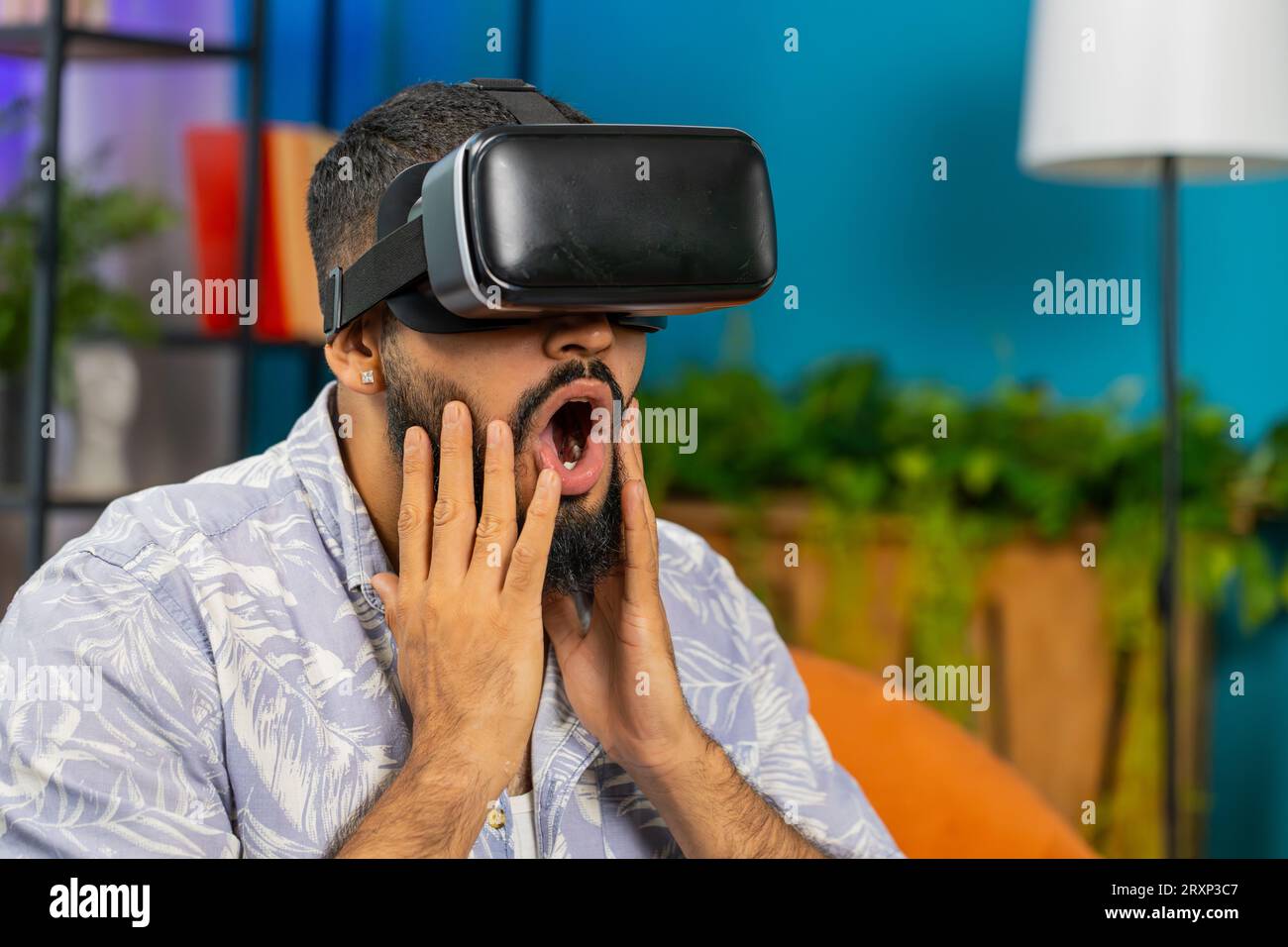 Indian man using virtual reality futuristic technology VR app headset ...