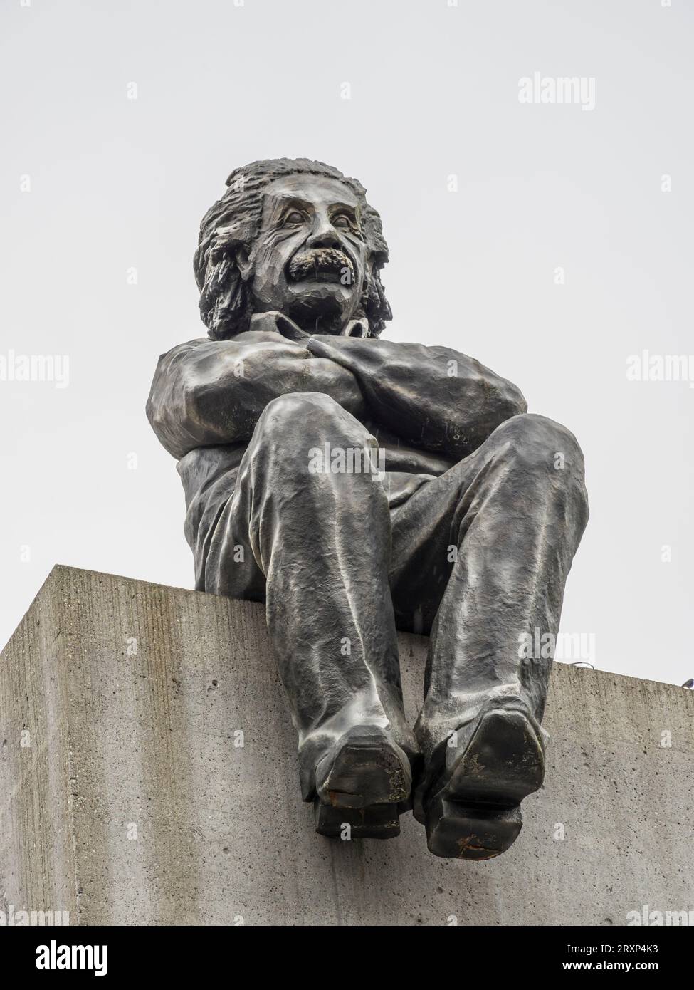 Sculputure of Albert Einstein sitting on the edge of a block, school for professionals, Baden, Aargau, Switzerland Stock Photo