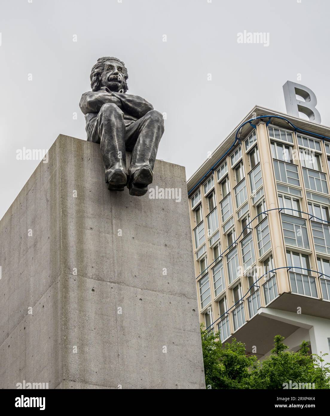 Sculputure of Albert Einstein sitting on the edge of a block, school for professionals, Baden, Aargau, Switzerland Stock Photo