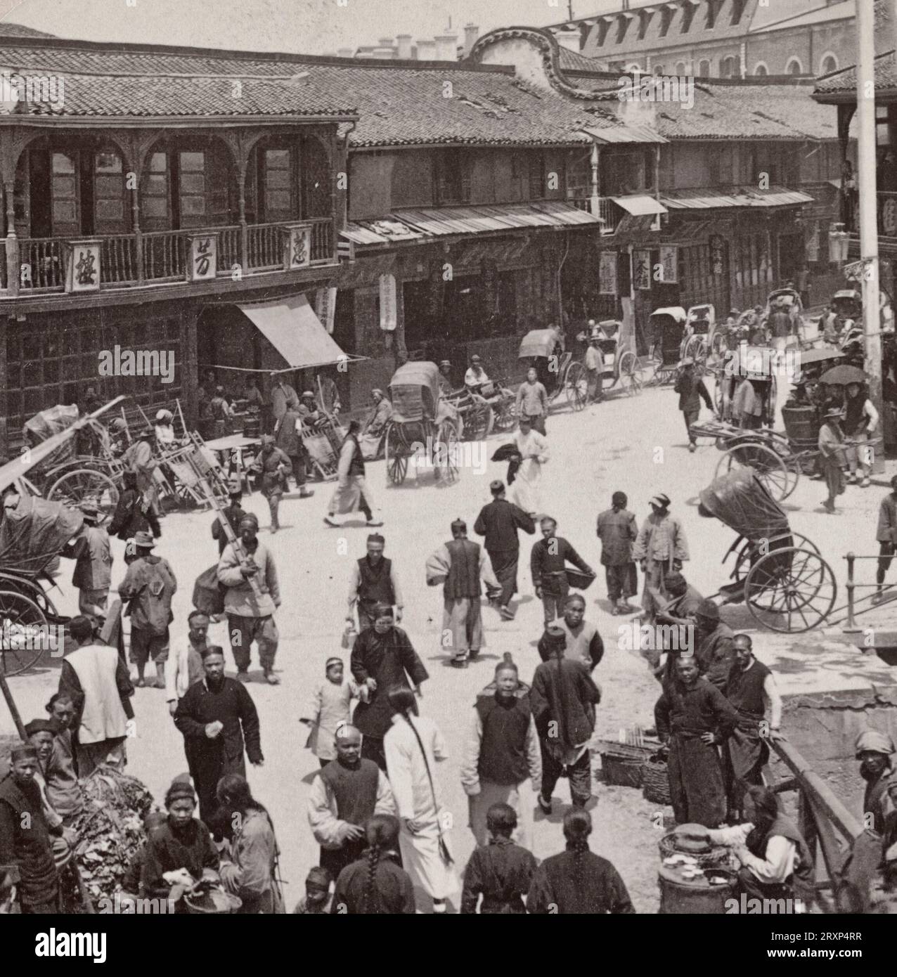 A busy street in old Shanghai - looking from city wall across canal into French concession, China, circa 1900 Stock Photo
