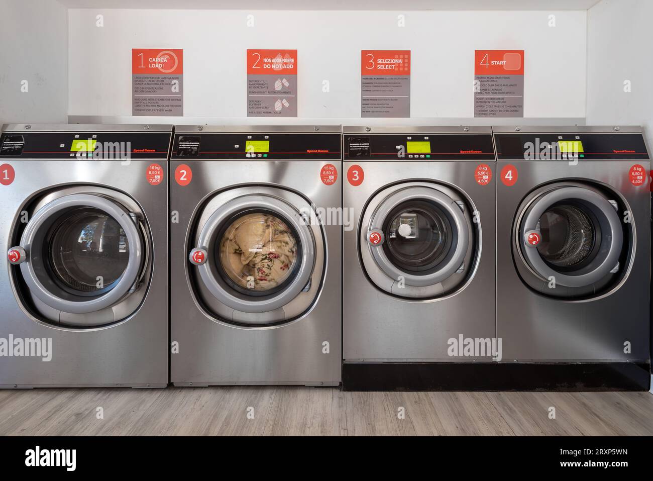 Fossano, Italy - September 26, 2023: Washing machines in Speed Queen chain self-service laundry, number one commercial laundry in the world Stock Photo