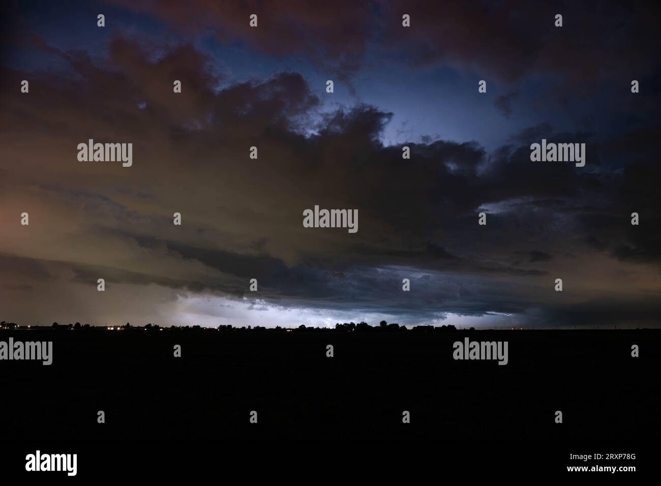 Menacing stormy sky is illuminated by lightning Stock Photo