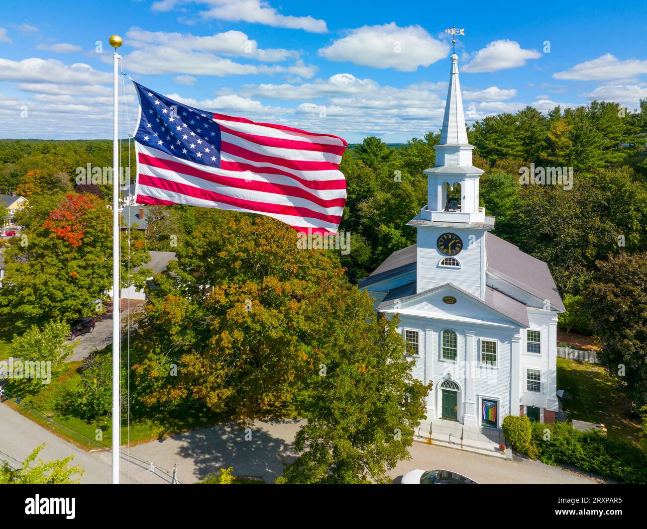 First Religious Society church aerial view at 27 School Street and US National Flag at Town Common in historic town center of Carlisle, Massachusetts Stock Photo