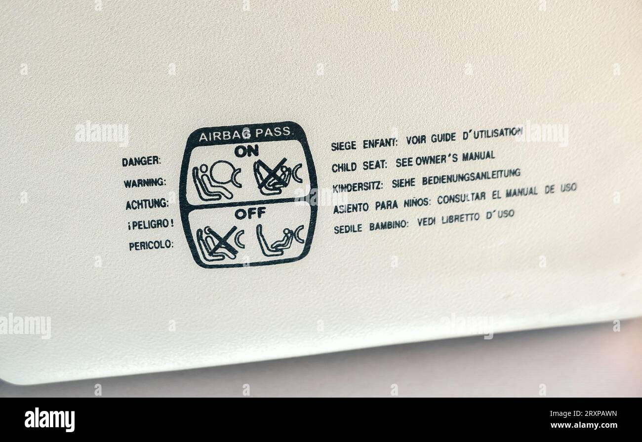 Child seat airbag warning in multiple languages in the car interior
