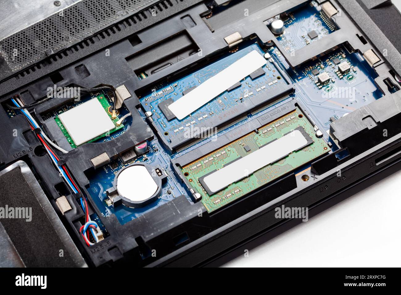 Opened modern laptop with back cover off being repaired, serviced, RAM