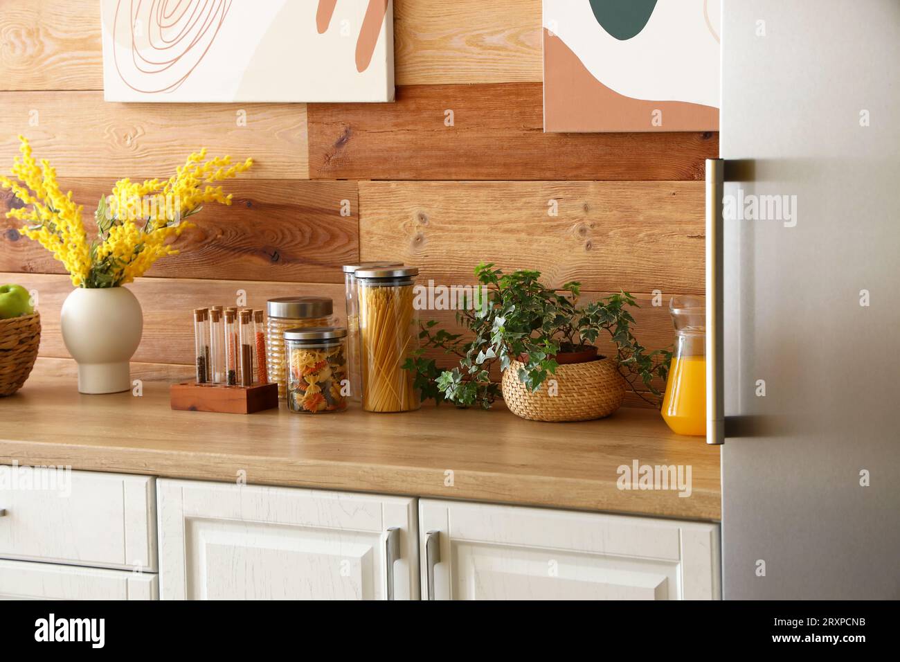 Interior of kitchen with stylish fridge, counters and houseplant ...