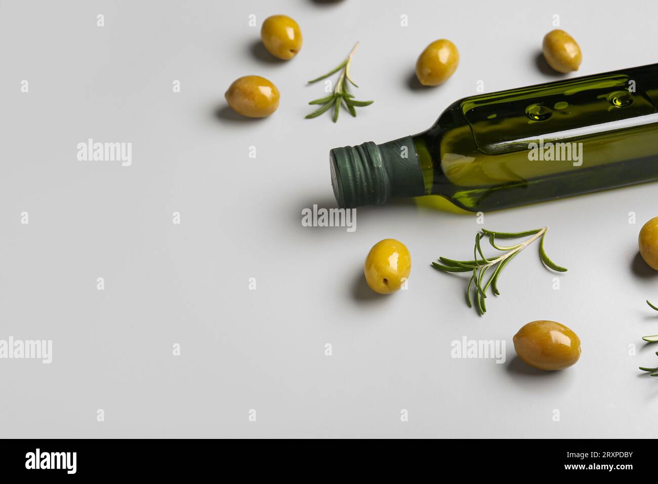 Bottle of olive oil on grey background Stock Photo - Alamy