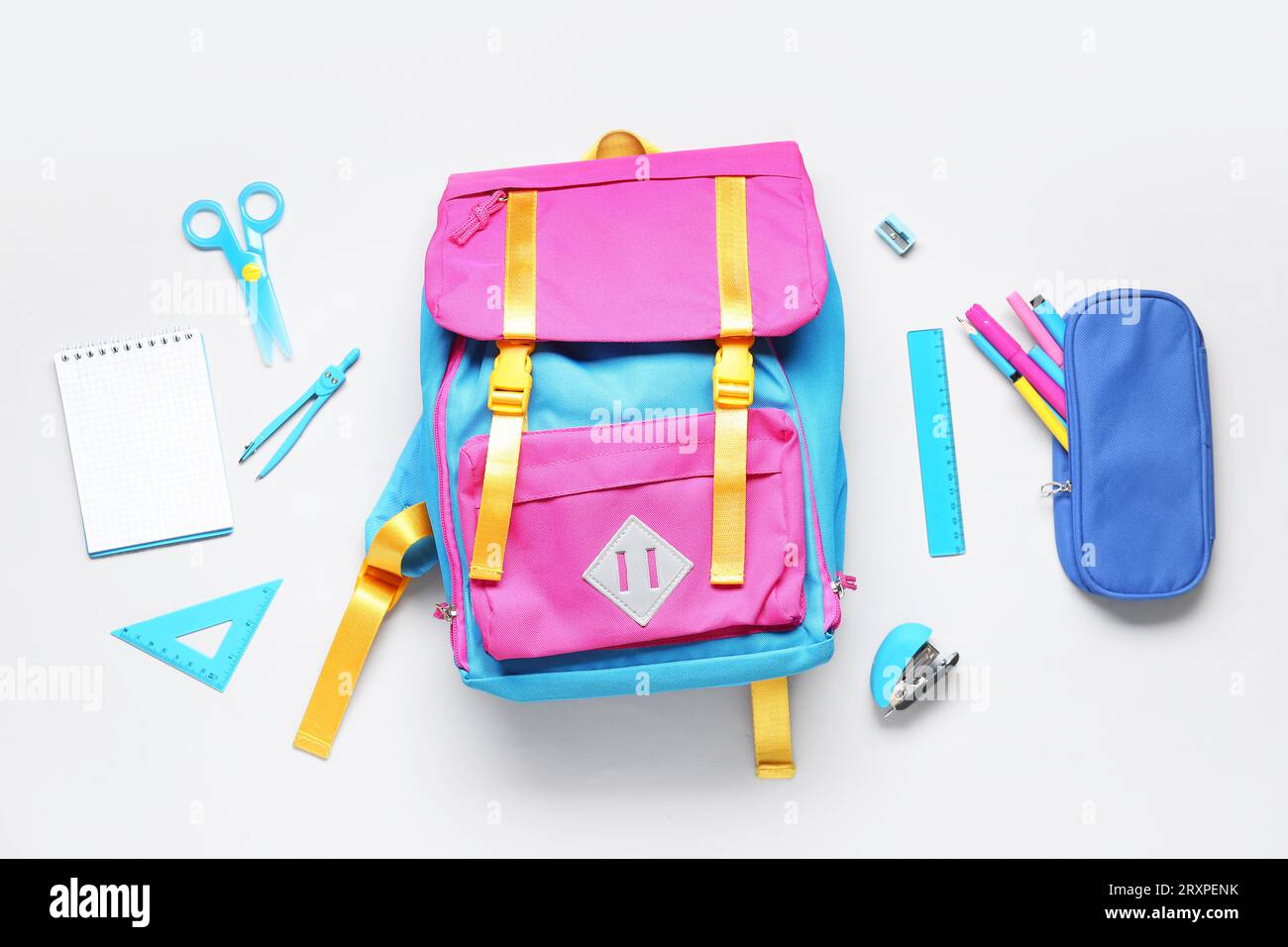 Stylish school backpack with different stationery on grey background Stock Photo